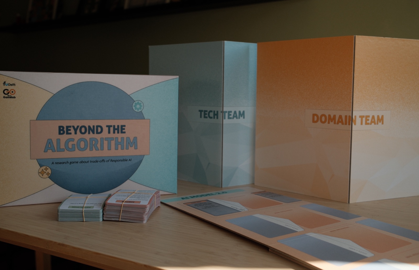 The box, the boards and the card decks set out on a table